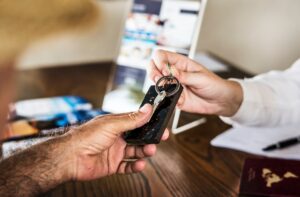 Receptionist handing room key to a guest